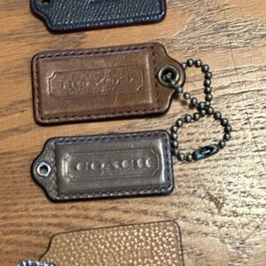 Various prices-coach Hangtags assorted colors and sizes. Metal tags as well.
